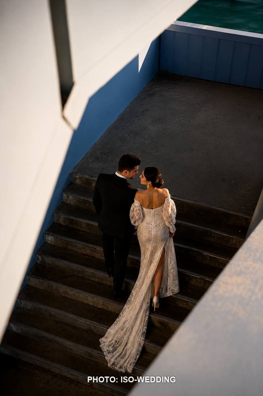 Bride and groom on Galata Bridge with the Galata Tower skyline behind them at golden hour