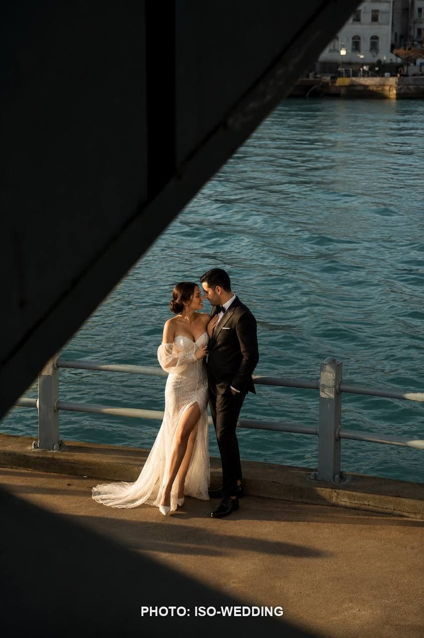 Bride and groom on Galata Bridge with the Galata Tower skyline behind them at golden hour