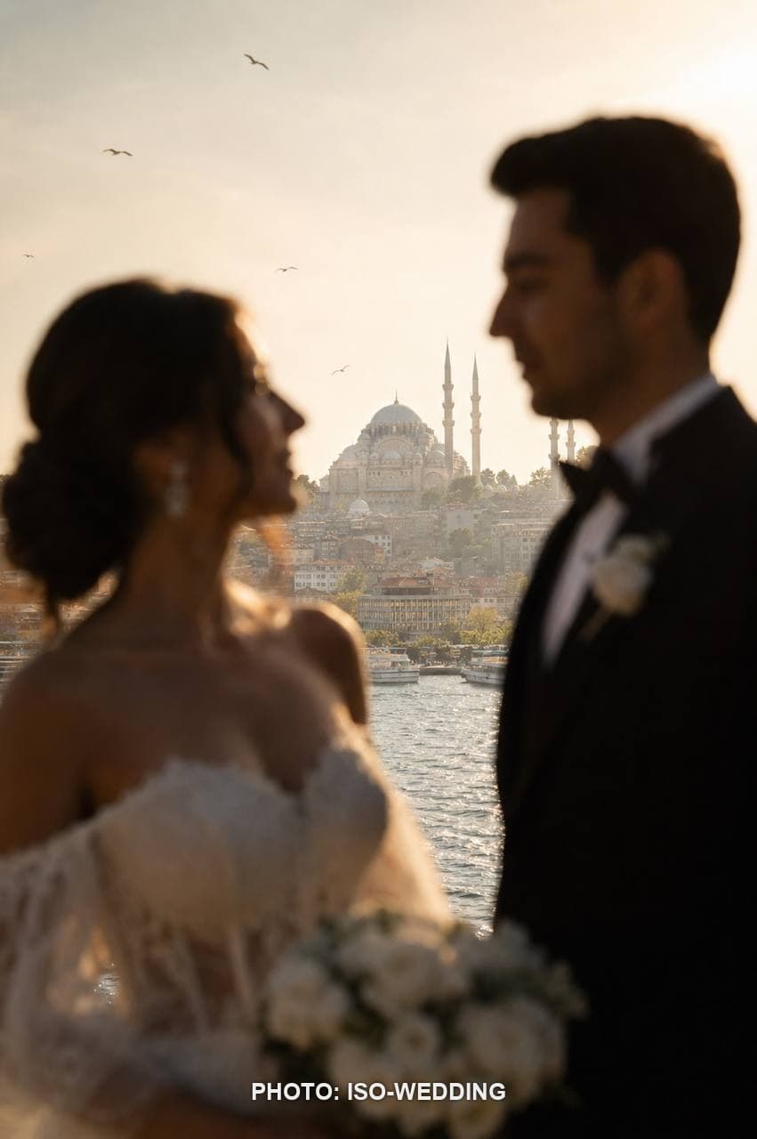 Bride and groom on Galata Bridge with the Galata Tower skyline behind them at golden hour