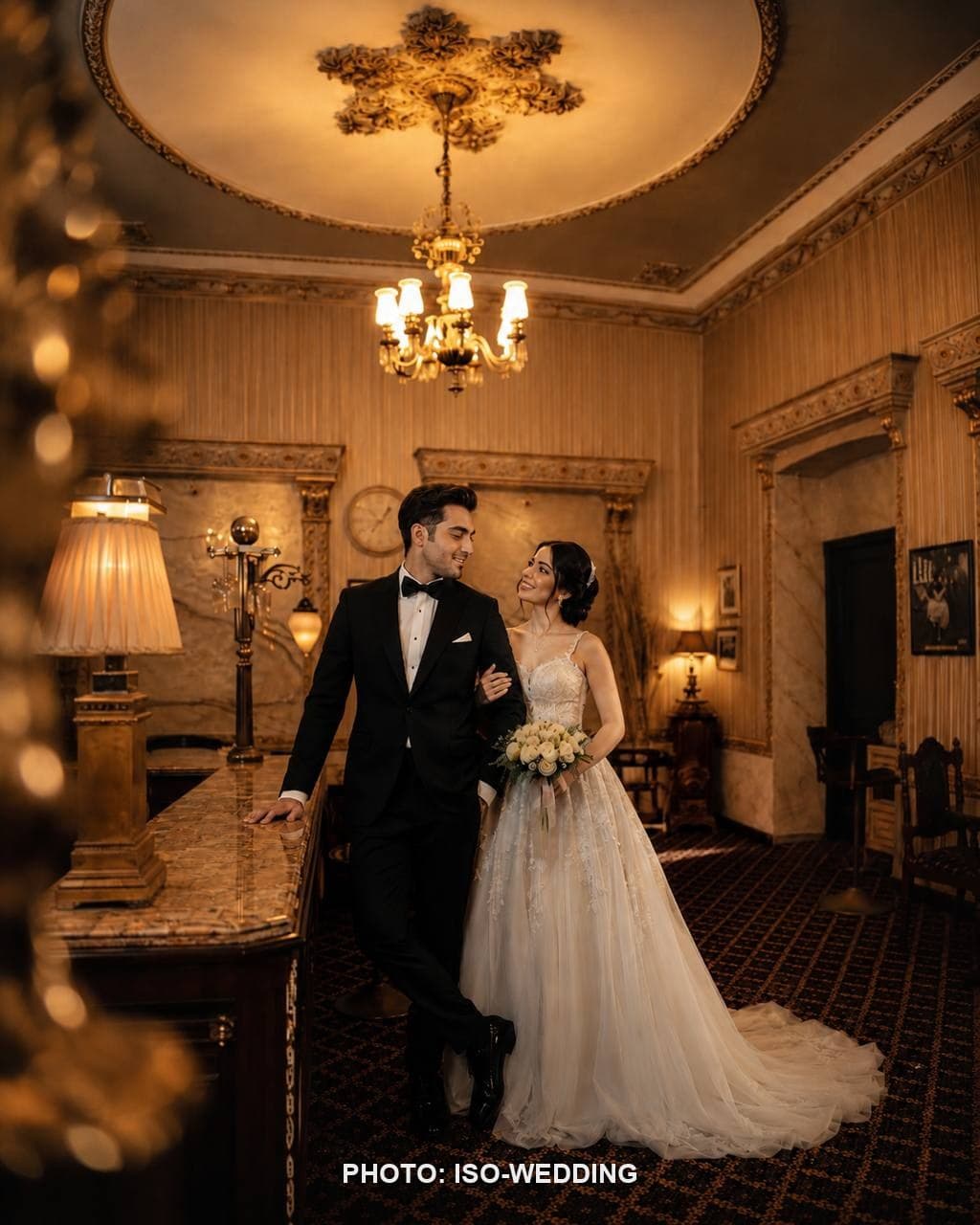 Bride and groom on the antique staircase of Grand Hotel de Londres in Istanbul
