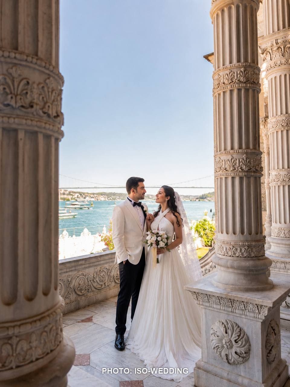 Bride and groom on the marble balcony of Küçüksu Palace overlooking the Bosphorus