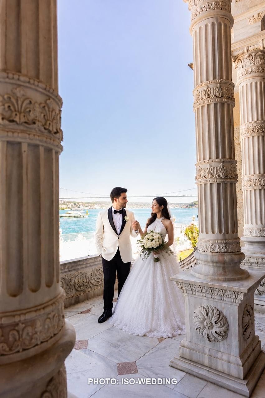 Bride and groom on the marble balcony of Küçüksu Palace overlooking the Bosphorus